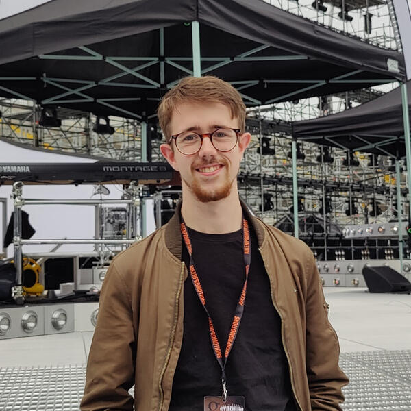Self Portrait Alex Sermon, Sound Engineer operating Mixer control for a Live Event.